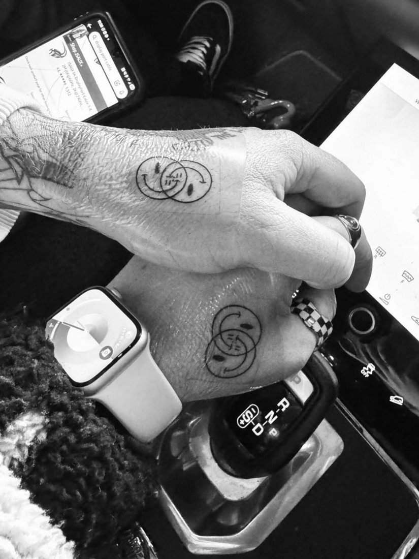 Amy and Shane’s tattooed hands together.
